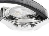 a close up of a watch on a white surface