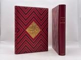 the book is red and gold with a gold diamond on the cover
