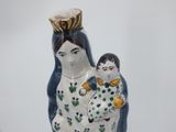a figurine of a woman holding a child