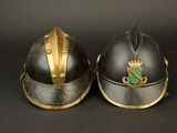 two helmets with gold trims and a crown on them