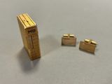 three pieces of gold colored metal on a table