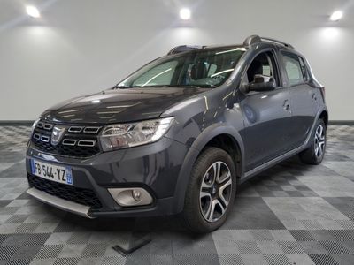 the grey dacia is parked on a checkered tile floor