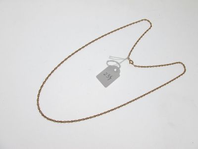 a close up of a necklace with a tag attached to it