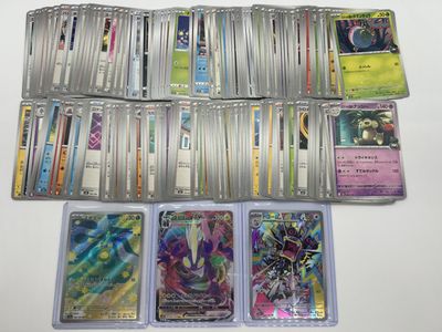 a lot of different pokemon cards on the table