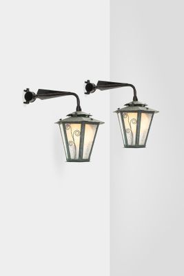 two light fixtures on a white wall in a room