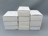 six white boxes stacked on top of each other on a gray surface