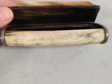 a person holding a wallet with a wooden handle