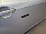 a close up of a car door handle with a sticker on it