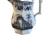 an image of a blue and white pitcher on a white background