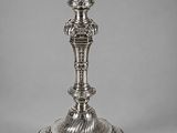 a silver plated candle holder on a grey background