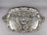 an antique silver plate with a floral design on it