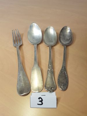 cinq cuillères et une fourchette posées sur une table