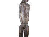 an image of a wooden statue of a person sitting on a stool