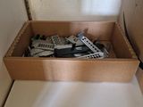 a box of remotes sitting on a white surface