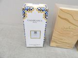 an image of a bottle of perfume next to a box of perfume