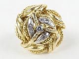 a close up of a gold and diamond ring on a white surface