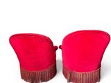 pair of red chairs with fringe trims on them against a white background