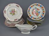 a lot of plates and a gravy dish on the table