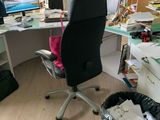 a desk with a chair and a trash can in front of it