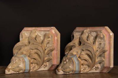 pair of carved wood bookends on a wooden table with a black background