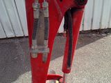 a red machine that is sitting on the ground