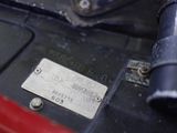 a close up of a motorcycle with a metal tag on it