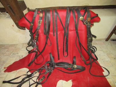 a red blanket with a bunch of black leathers on it