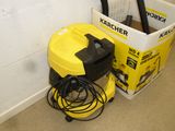 a yellow and black vacuum next to a white bucket