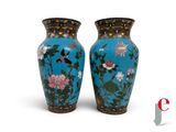 pair of blue vases with flowers and birds on them on a white background