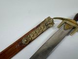 a knife that is sitting next to a knife on a table