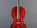 a red cello sitting on a stand against a gray background