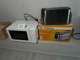two microwaves sitting on a shelf next to each other