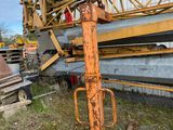 a crane that is sitting on the ground next to a building