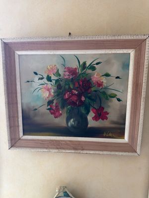 a painting of flowers in a vase on the wall