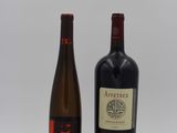 two bottles of wine sitting next to each other on a table