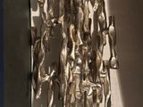a silver sculpture of a man riding a horse in a box