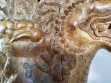 a close up of a statue of a horse with a dragon on it ' s back
