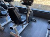 a row of stationary exercise bikes in a gym