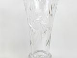 clear glass vase on a white surface with a white background