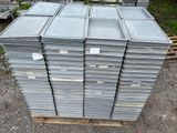 many stacks of metal containers stacked on a pallet