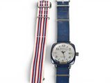 a close up of a wrist watch with a red, white and blue strap