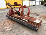 a red machine that is sitting on the ground