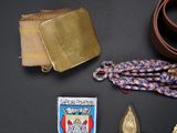 several military items including a belt, badge, and other items
