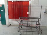 a red curtain hanging on the wall next to a metal cart