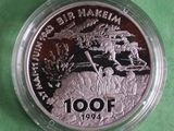 a close up of a coin on a table with a green background