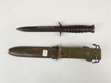 two knives are laying side by side on a white surface