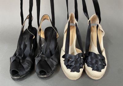 four pairs of black and white shoes hanging from a rack