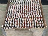 many bottles of syrup in a wooden crate