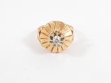 a close up of a gold ring with a diamond in the center