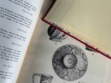 an open book with a drawing of vases on it